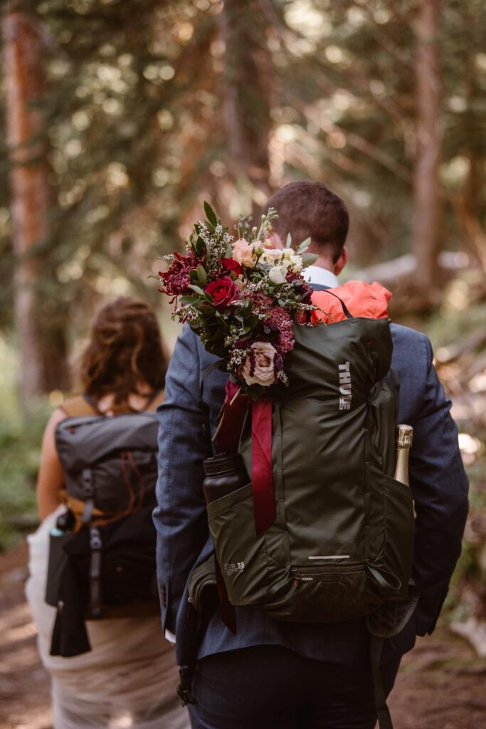 Bride and groom with wedding bouquet in backpack