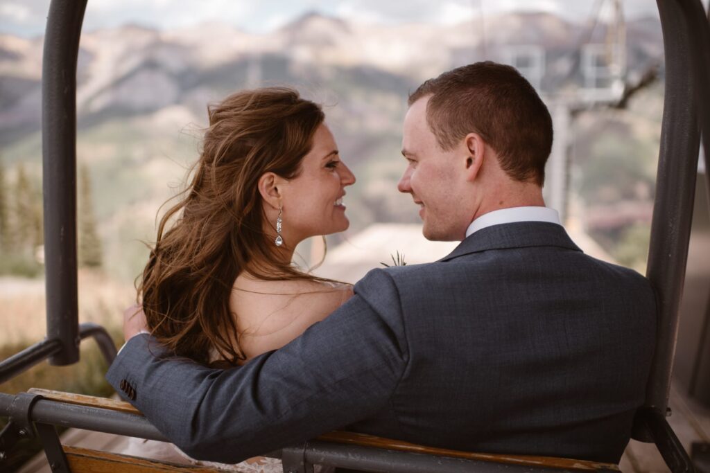Couple riding the ski lift in Telluride, Colorado on their wedding day