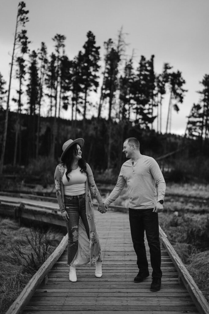 Couple dancing on the boardwalk through the woods