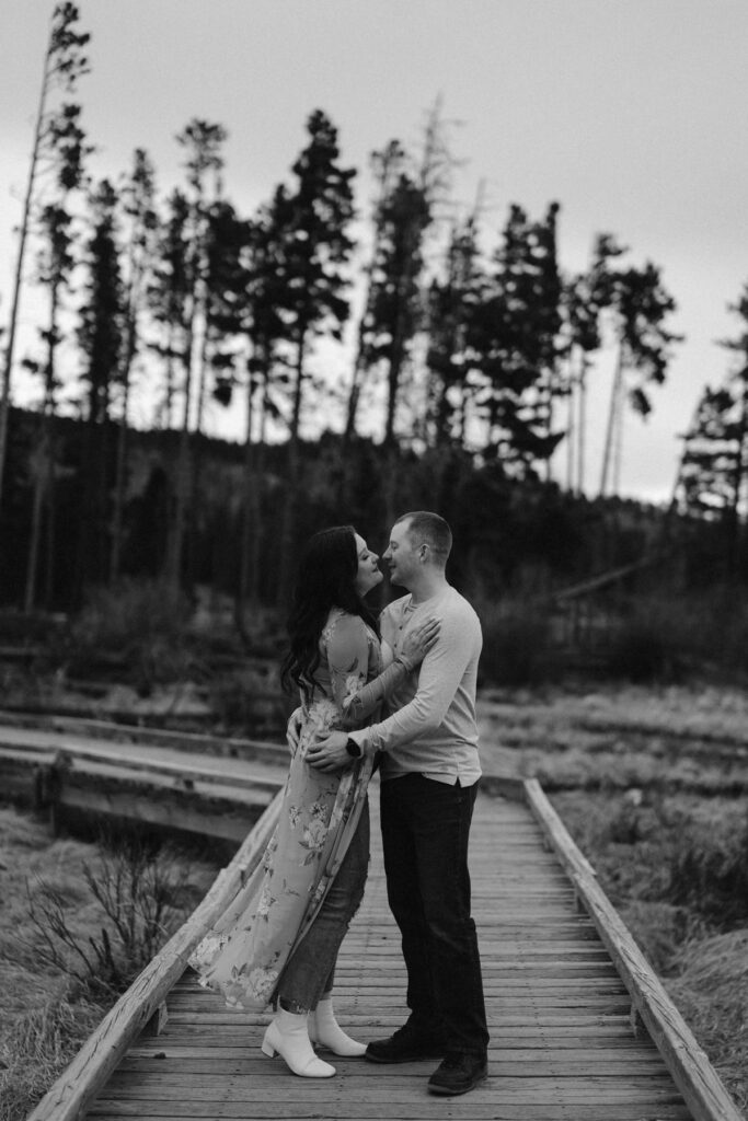 Couple kissing during their mountain engagement photo session