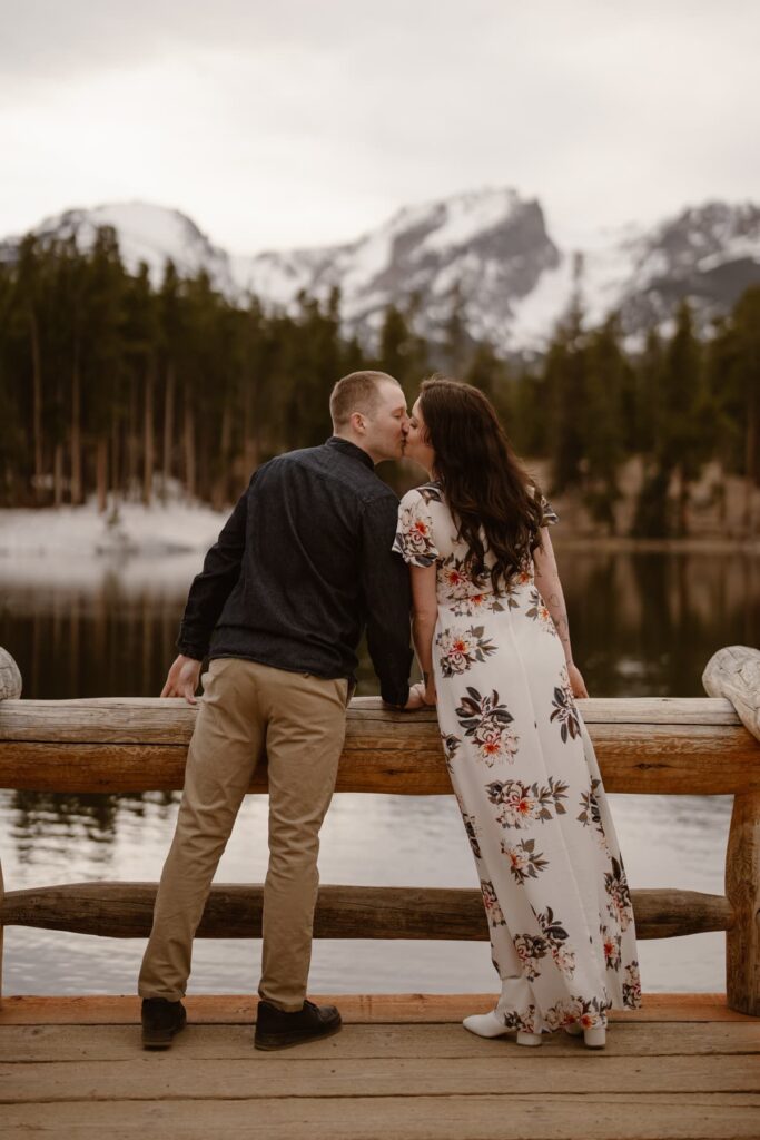 Engagement photos of couple kissing on the dock at Sprague Lake