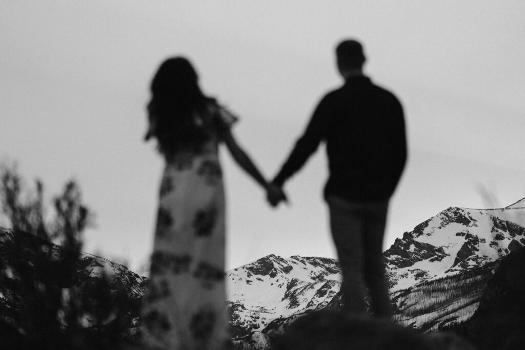 Epic portrait of couple holding hands in the mountains