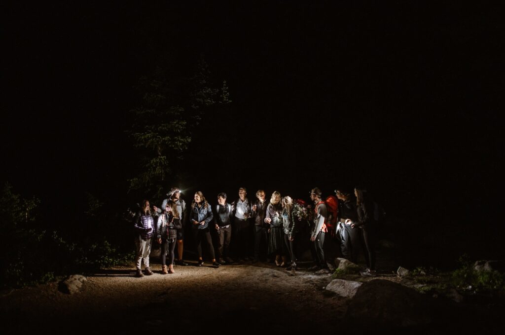 Family and friends all lined up with headlamps on during hike