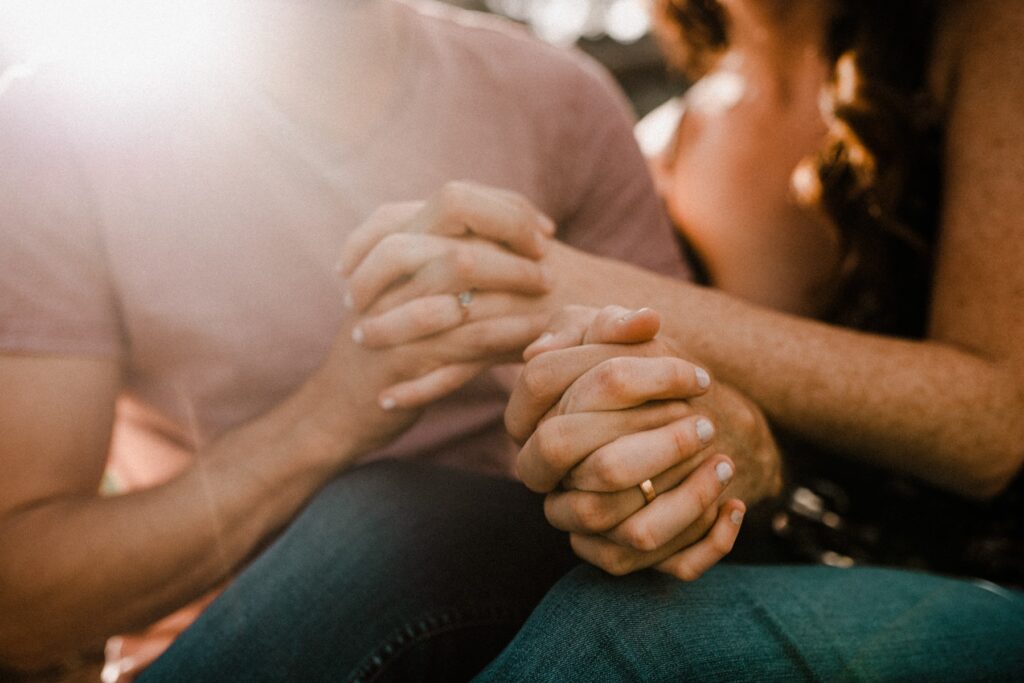 Couple holding hands after just getting engaged